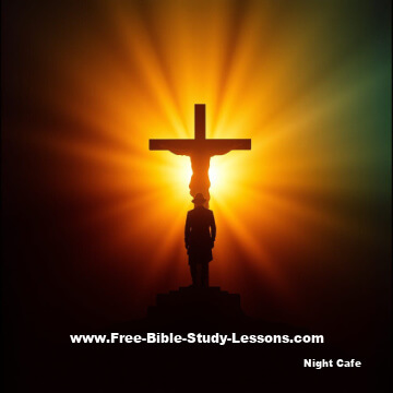 Man standing before cross at sunrise